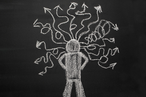 Chalkboard with chalk drawing of a student with squiggly arrows
